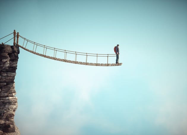 Surreal scene with a rope bridge cut in half suggesting the concept of dead end or impossible situation. Surreal scene with a rope bridge cut in half suggesting the concept of dead end or impossible situation.