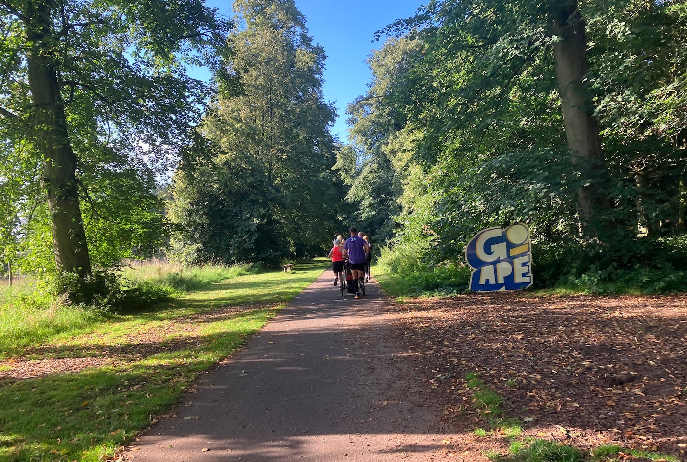 Running past a Go Ape sign in the woods Running past a Go Ape sign in the woods