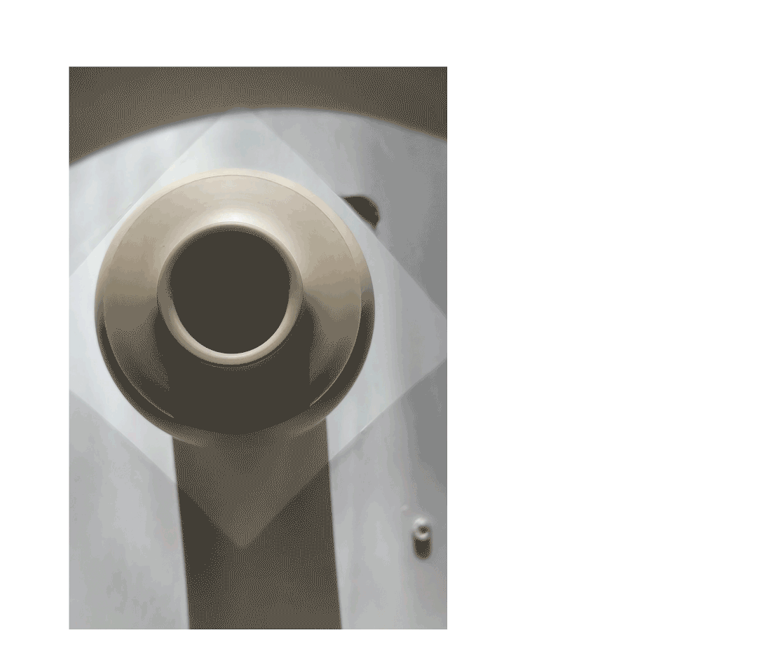 Animated gif of footage showing a close-up of a clay vessel revolving on the wheel from above. The movement can't be perceived by looking at the pot alone.