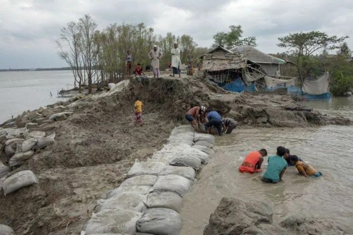 As pessoas que vivem na Baía de Bengala conhecem bem os desastres naturais. Aqui, os moradores tentam reparar a barragem quebrada após a chegada do ciclone Amphan em Satkhira, uma cidade na Baía de Bengala, na primavera de 2020. (Crédito da imagem: KM Asad/Getty Images) As pessoas que vivem na Baía de Bengala conhecem bem os desastres naturais. Aqui, os moradores tentam reparar a barragem quebrada após a chegada do ciclone Amphan em Satkhira, uma cidade na Baía de Bengala, na primavera de 2020. (Crédito da imagem: KM Asad/Getty Images)