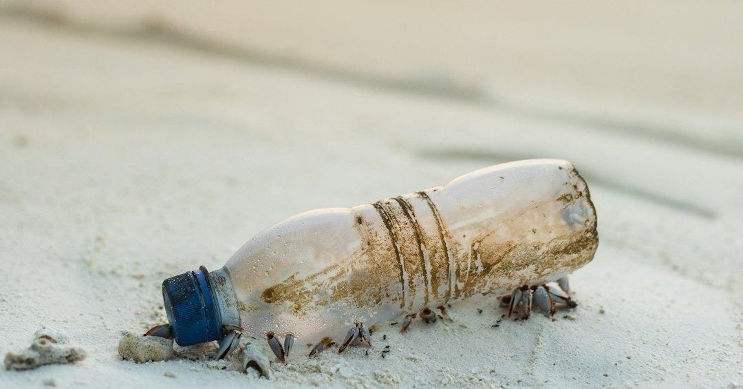 clear plastic bottle beside beach clear plastic bottle beside beach