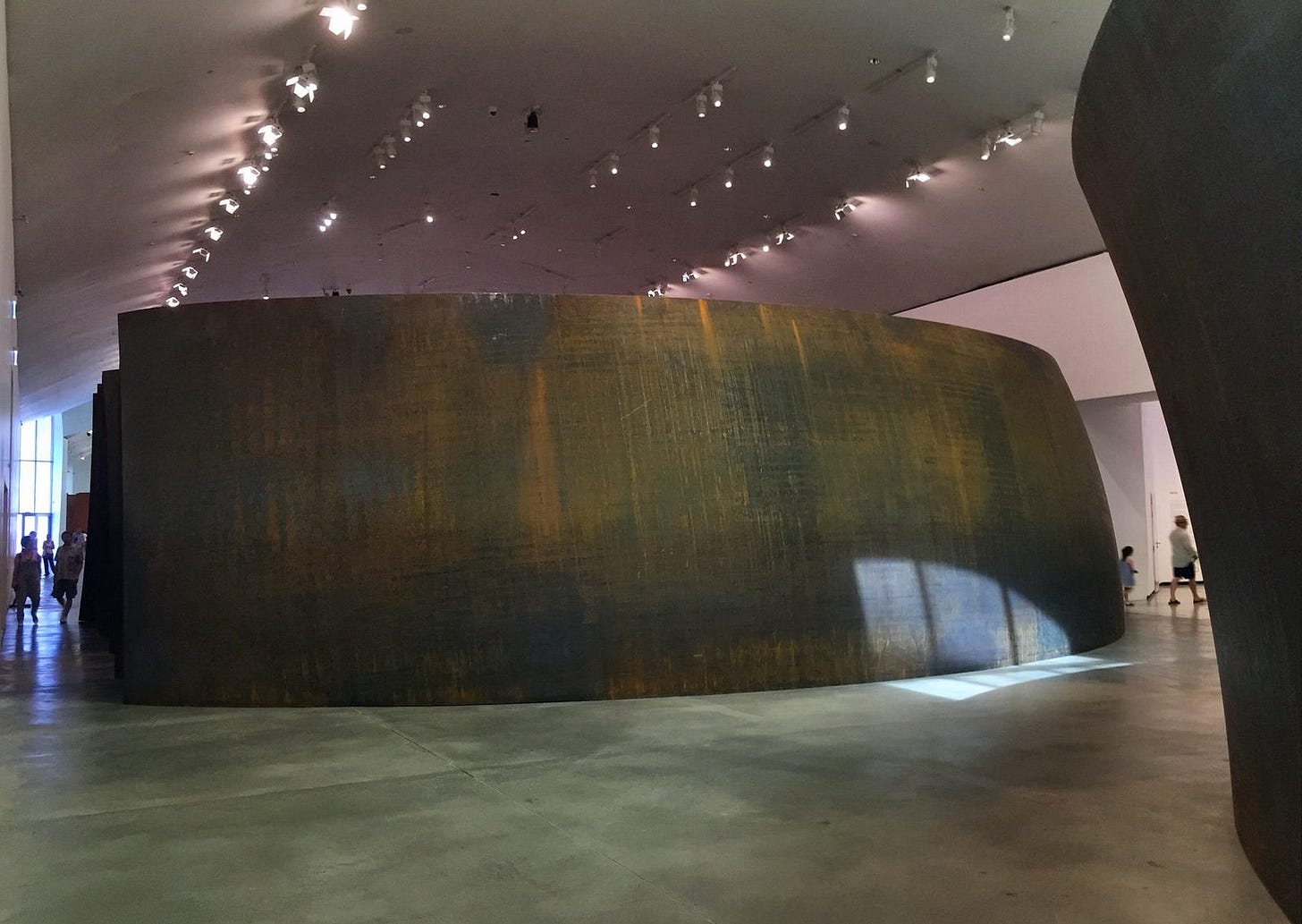 Inside the Guggenheim, looking at a massive bent steel plate about four meters high.
