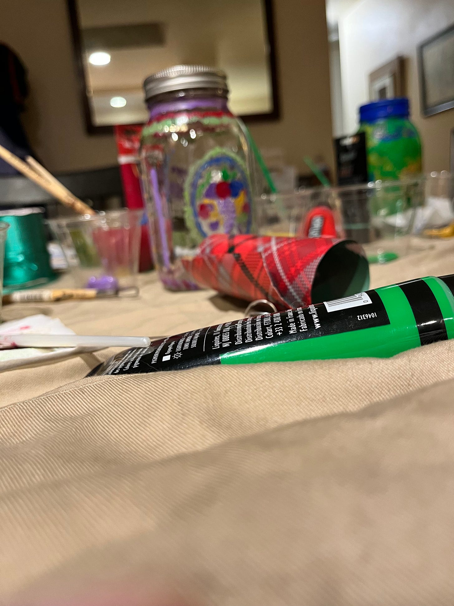 paint and jars litter a table where folks did crafts