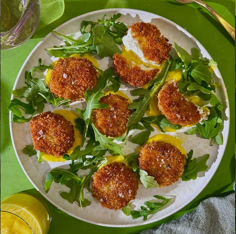 Collage of 7 easy summer appetizer recipes including golden fried zucchini blossoms, crispy eggplant rounds, loaded smashed potatoes, corn rangoons, panko-crusted goat cheese balls, pea fritters, and olive crostini - all ready in 30 minutes or less