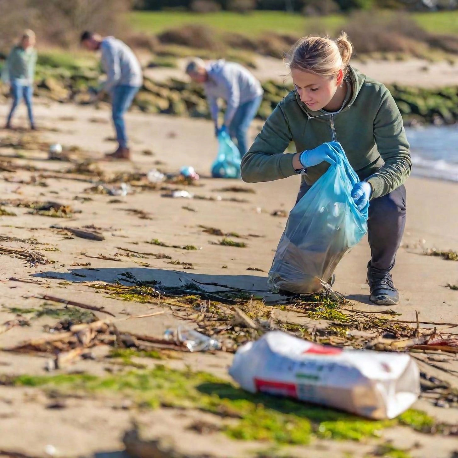 Volunteers picking up trash at a beach