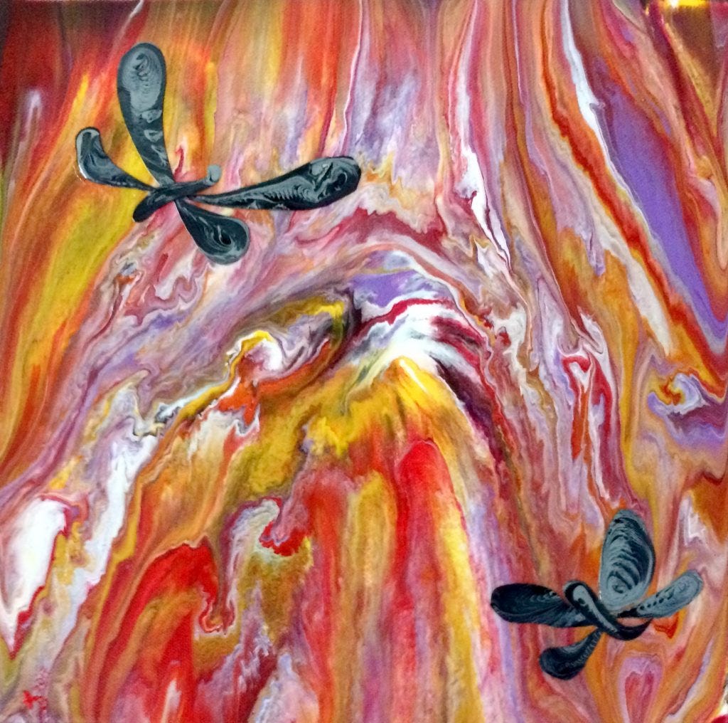 Fiery, colorful swooping lines in background in yellow, red and purple.  2 black dragonflies fly in front.