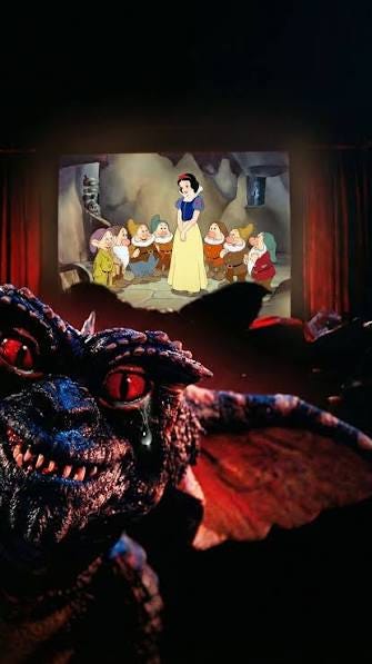 scene of Gremlins at the movie theater watching snow white; one evil gremlin is looking at the camera with a toothy grin scene of Gremlins at the movie theater watching snow white; one evil gremlin is looking at the camera with a toothy grin