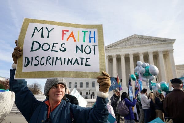 A demonstrator outside of the Supreme Court holding a sign. The sign reads “my faith does not discriminate.” A demonstrator outside of the Supreme Court holding a sign. The sign reads “my faith does not discriminate.”