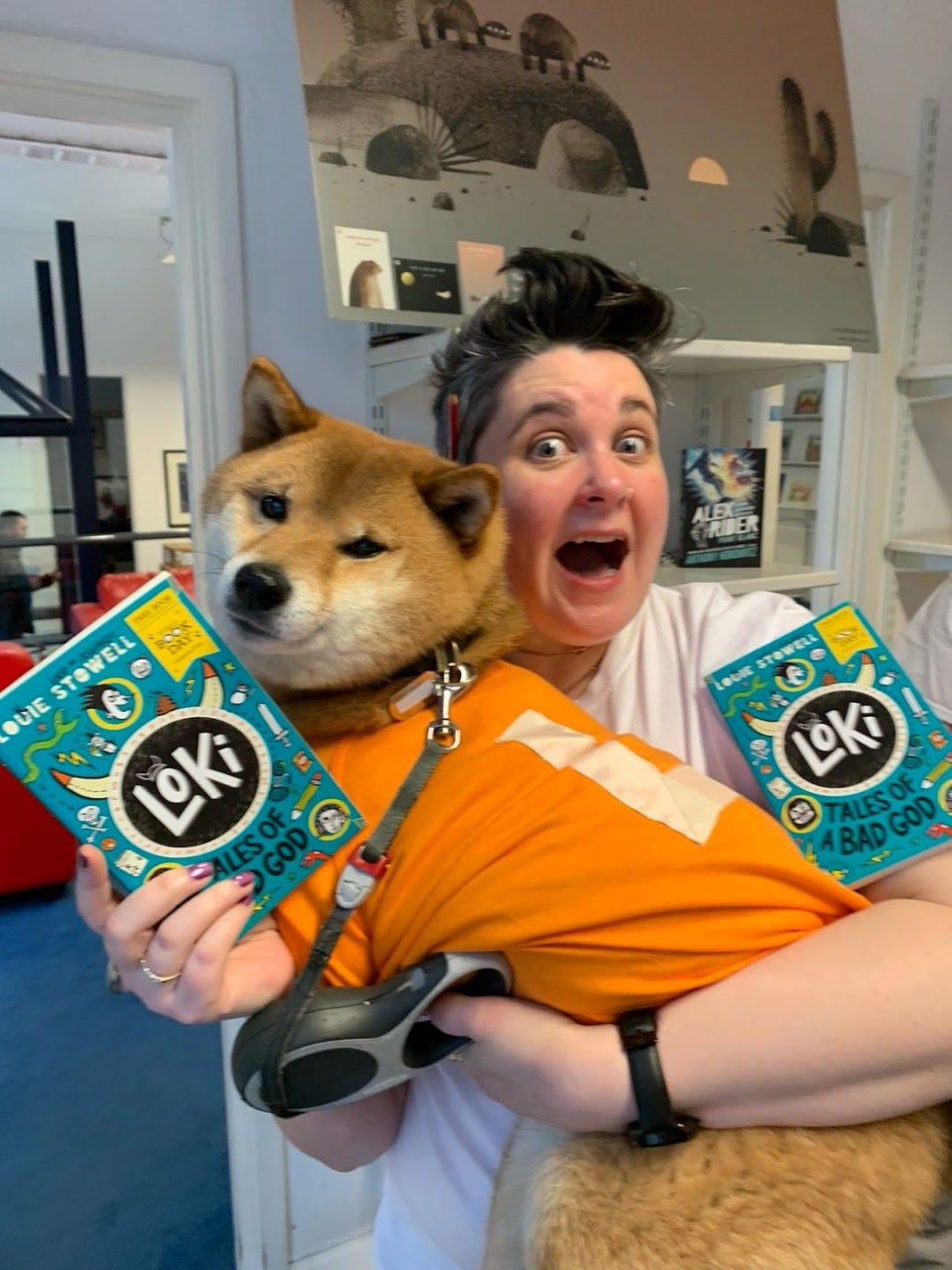 Non Pratt dressed as Loki holding a dog also dressed as Loki plus a couple of copies of my World Book Day Book