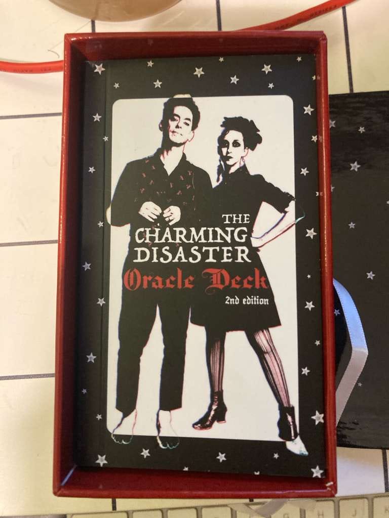 Charming Disaster Oracle Deck second edition box with a black, white and red gothic design Charming Disaster Oracle Deck second edition box with a black, white and red gothic design