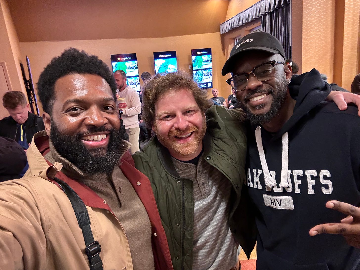 Selfie with three men in foreground. Baratunde left, Matt Klinman in middle, Willonius Hatcher on right. Background is lobby of movie theatre in Los Angeles Selfie with three men in foreground. Baratunde left, Matt Klinman in middle, Willonius Hatcher on right. Background is lobby of movie theatre in Los Angeles