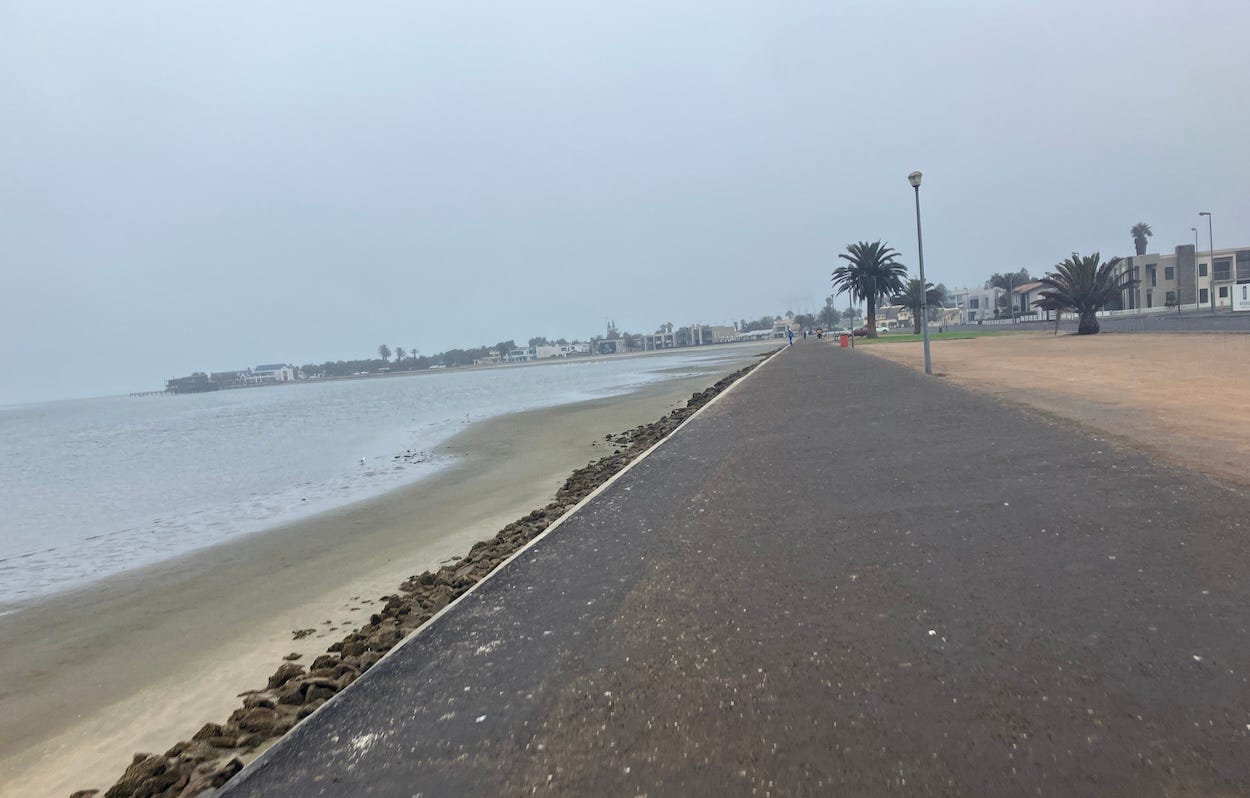 Flat wide path past lagoon and sandy area