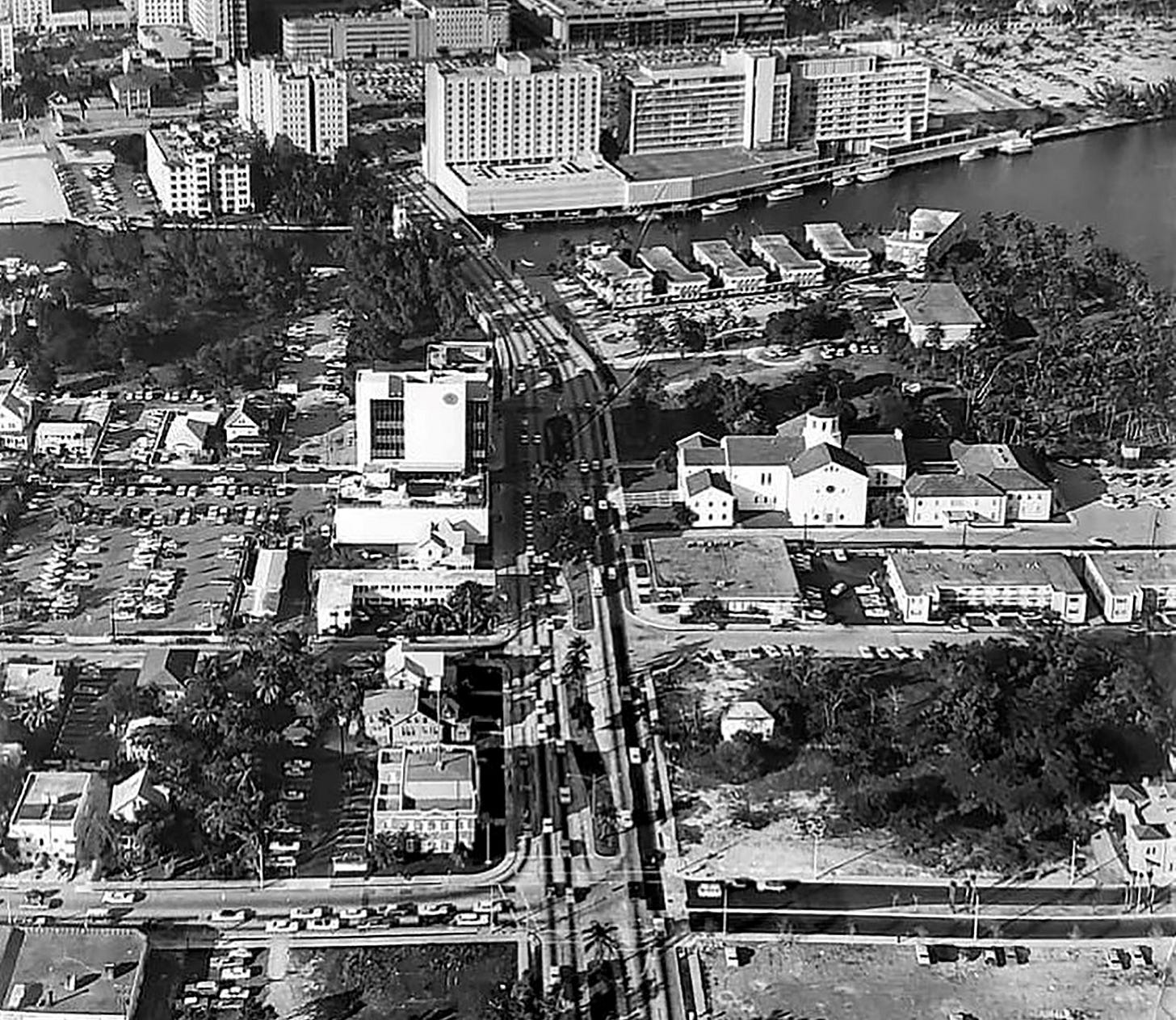 Figure 5: Aerial of Brickell Avenue in 1968. The commercial building and Harbor Inlet Apartments are just below the First Presbyterian Church. Figure 5: Aerial of Brickell Avenue in 1968. The commercial building and Harbor Inlet Apartments are just below the First Presbyterian Church.