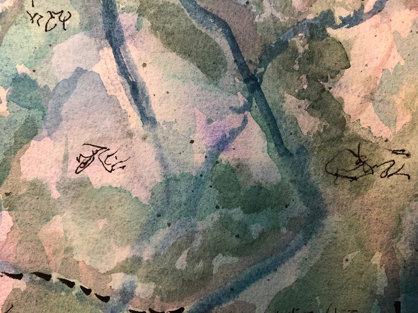 Close-up of an abstract watercolor painting in muted green, blue, and lavender tones, with dark ink brushstrokes and calligraphic marks layered across the textured paper.