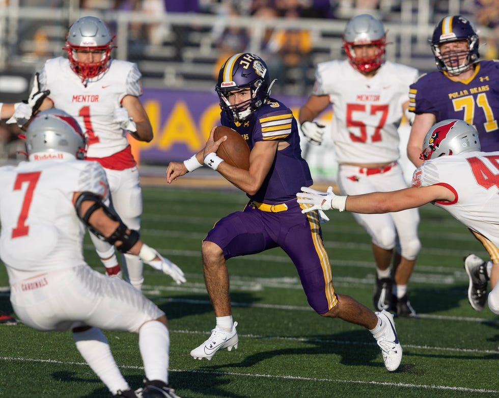 Jackson quarterback Lucas Ecrement keeps the ball for a first-quarter gain against Mentor, Friday, Aug. 18, 2023. Jackson quarterback Lucas Ecrement keeps the ball for a first-quarter gain against Mentor, Friday, Aug. 18, 2023.