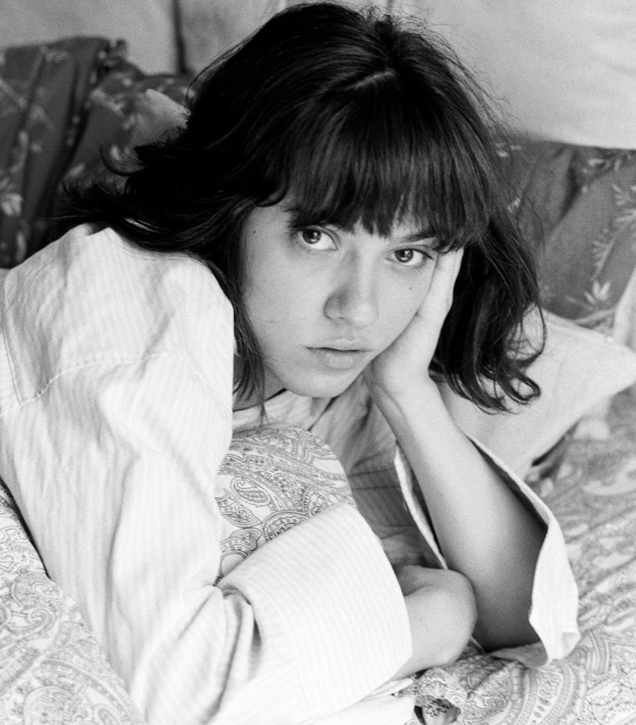 Black and white image of a woman lying on a bed, her face resting on her hand. She gazes ahead with a quiet, contemplative expression — capturing the stillness, self-doubt, and soft honesty explored in the article about fear, worthiness, and trusting the quiet rhythm of being. Black and white image of a woman lying on a bed, her face resting on her hand. She gazes ahead with a quiet, contemplative expression — capturing the stillness, self-doubt, and soft honesty explored in the article about fear, worthiness, and trusting the quiet rhythm of being.