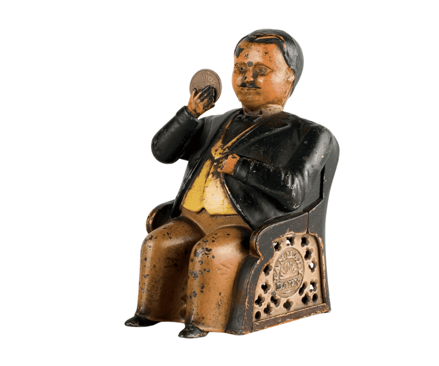 Coin bank showing a statuette of a man sitting in armchair with a real coin in his hand