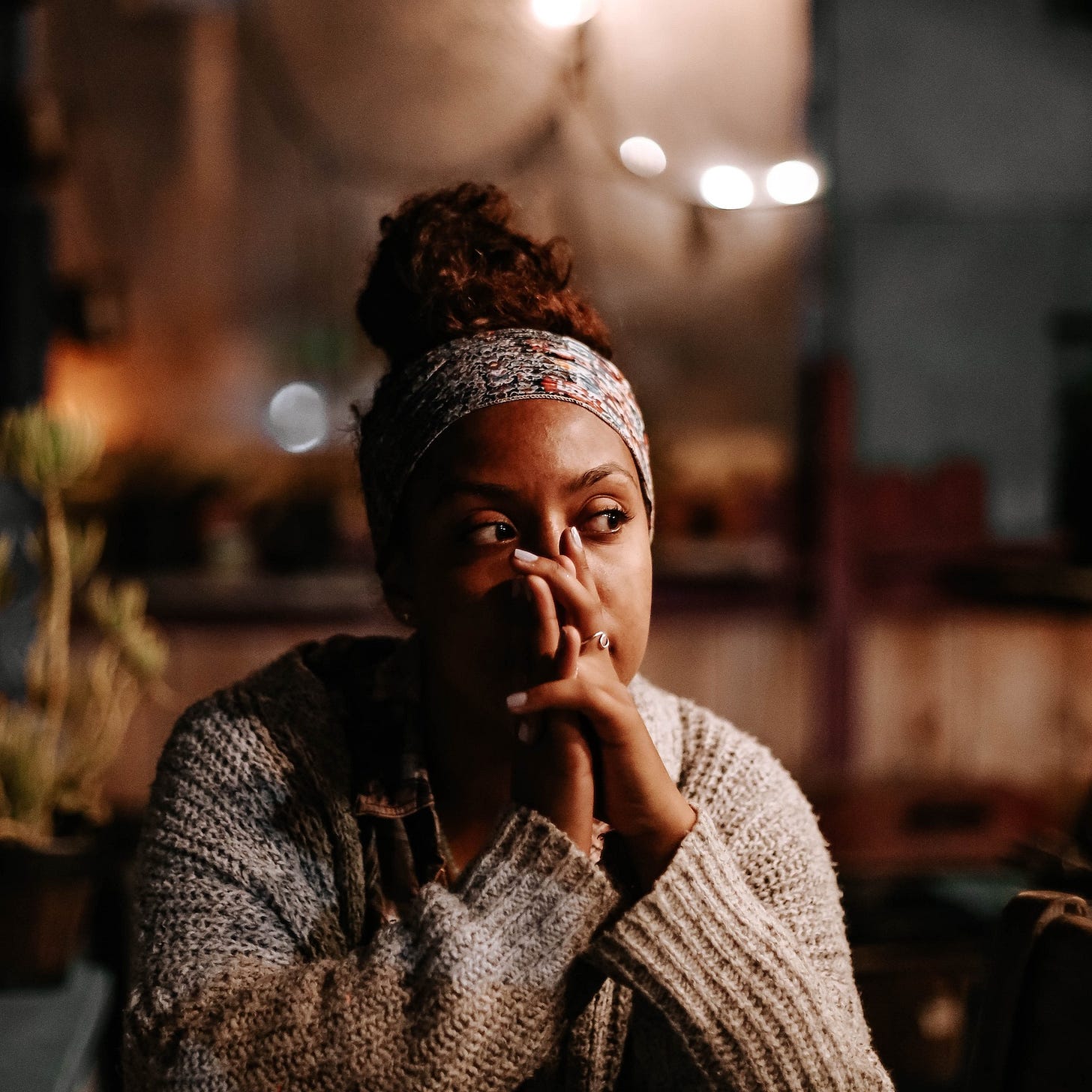 Woman sitting at a table and thinking Woman sitting at a table and thinking