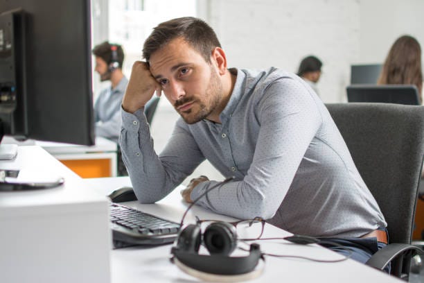 Worried beard man looking at computer screen in office Worried beard man looking at computer screen in office depressing job stock pictures, royalty-free photos & images