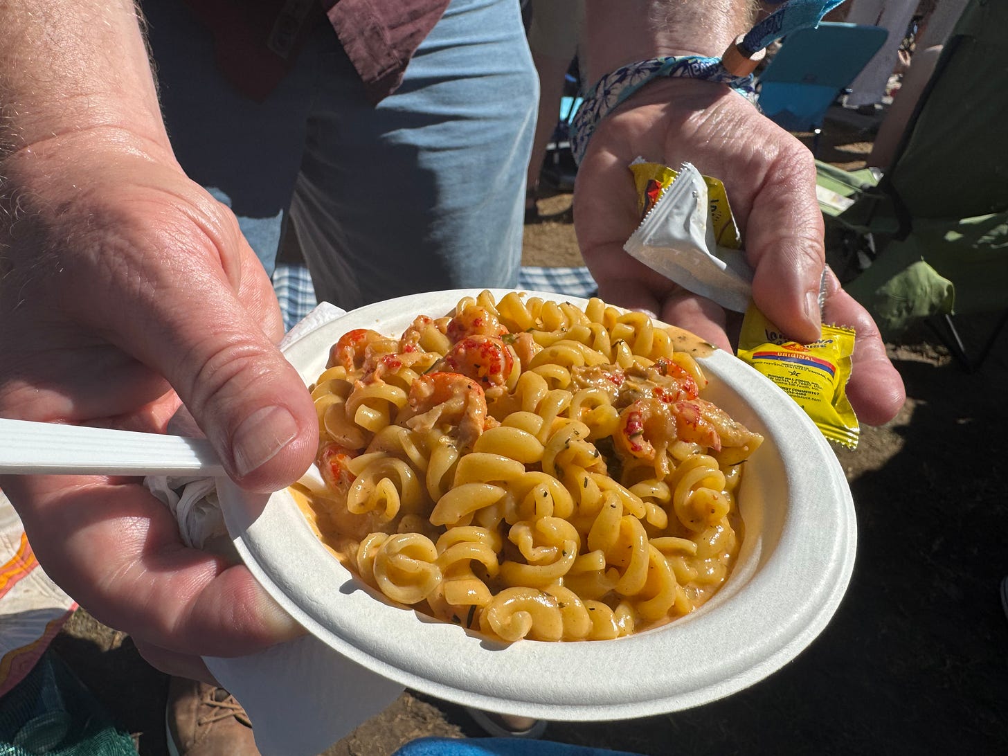 paper bowl of spiral pasta with crawfish tails paper bowl of spiral pasta with crawfish tails