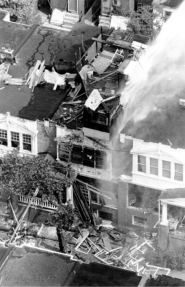 Residents and onlookers gather behind barricades, witnessing the tragic unfolding of events. Residents and onlookers gather behind barricades, witnessing the tragic unfolding of events.