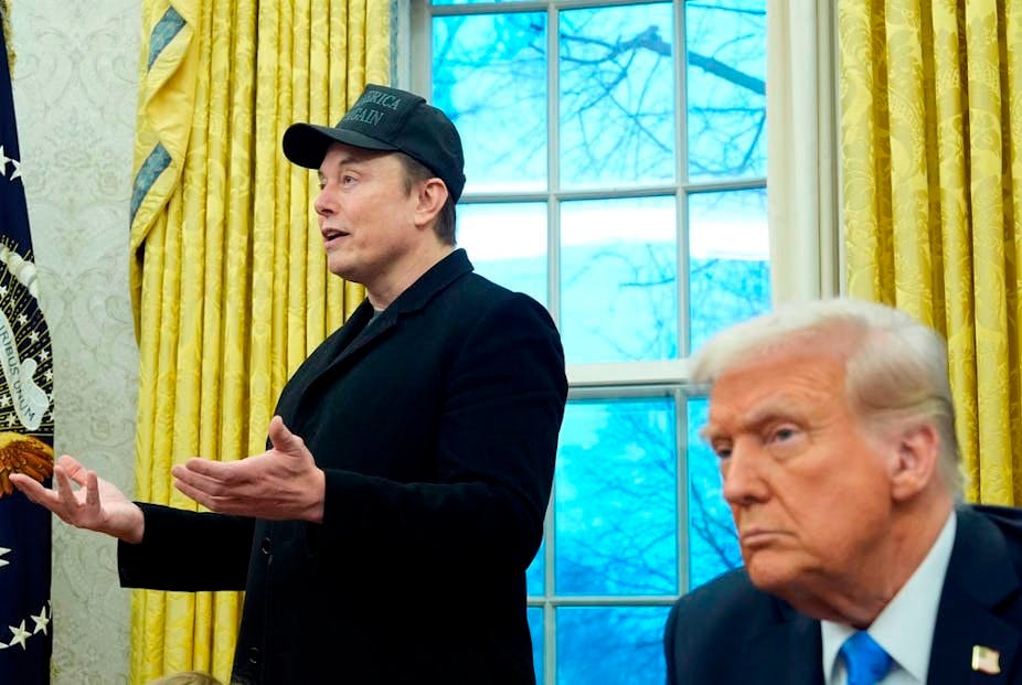 Two men in office hold press briefing.