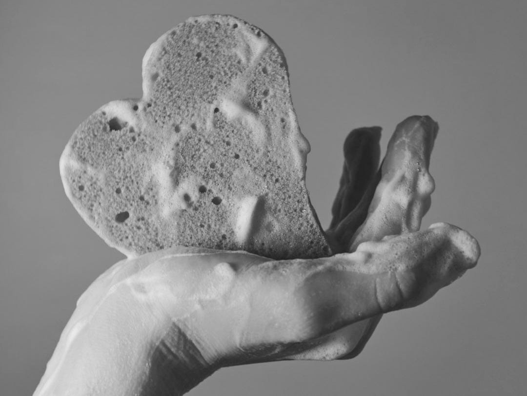 person holding pink heart shaped ornament