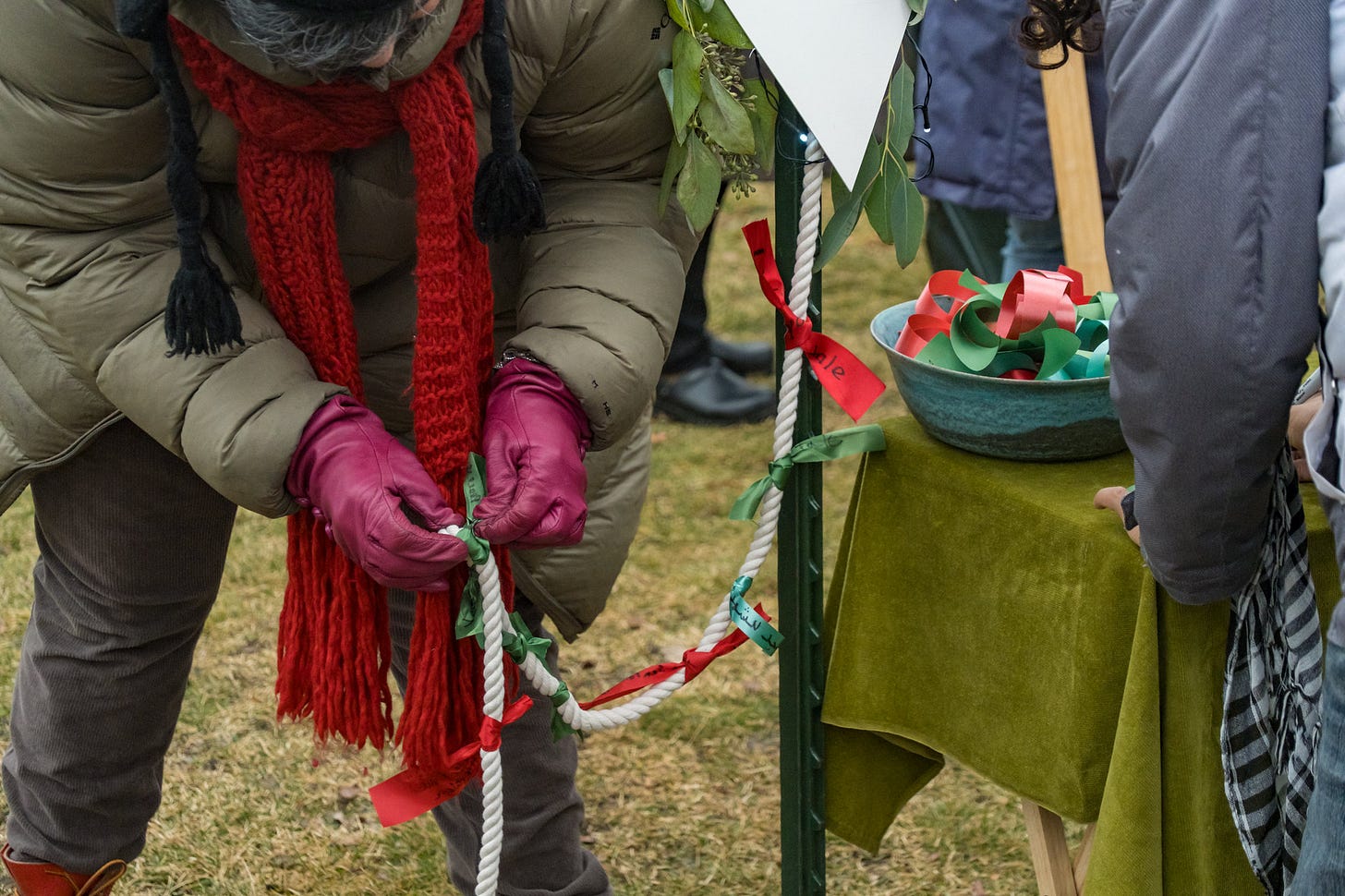 A protester ties messages on ribbons to the take of a kite.