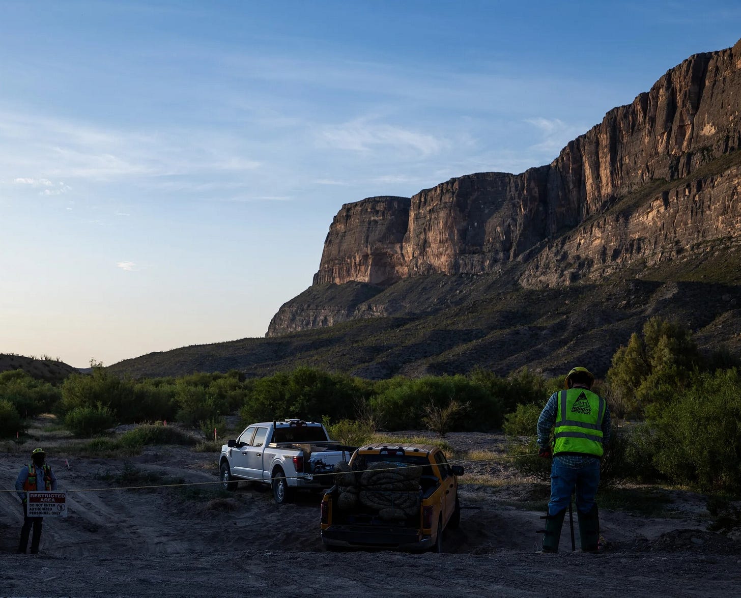 Southwest Valley employees install T posts and rope along a leveled river access area off Ross Maxwell Scenic Drive in Big Bend National Park on Aug. 13, 2026. (Photo by Kaylee Greenlee for The Texas Tribune) Southwest Valley employees install T posts and rope along a leveled river access area off Ross Maxwell Scenic Drive in Big Bend National Park on Aug. 13, 2026. (Photo by Kaylee Greenlee for The Texas Tribune)