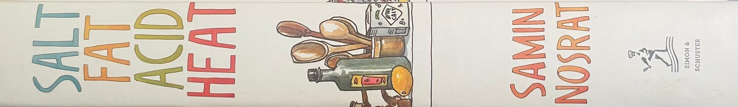 Book spine for Salt Fat Acid Heat by Samin Nosrat. White cover with multicolored words and watercolor cooking tool display.