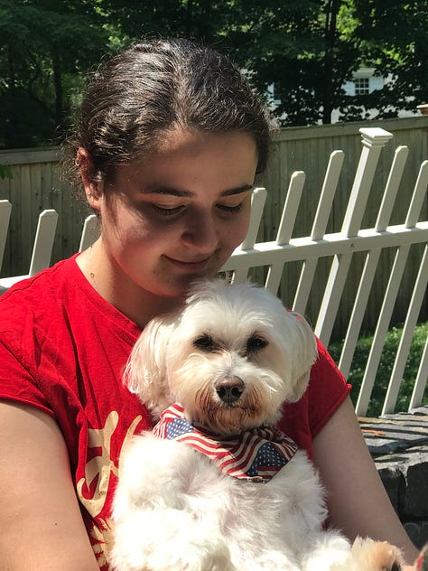 White Havanese with various family members who are all smiling