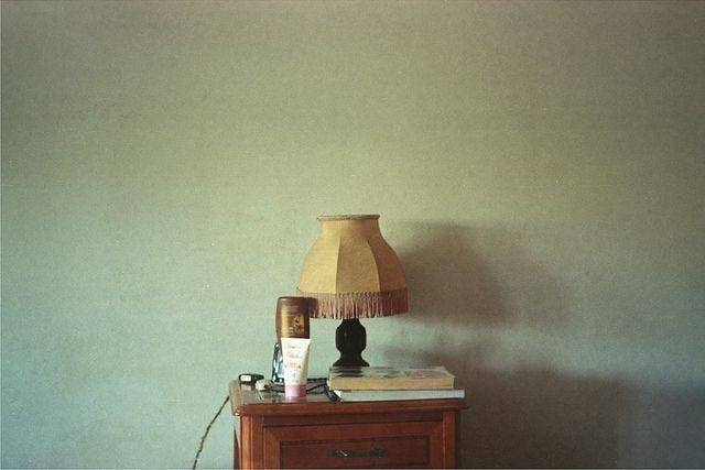 This may contain: a lamp and some items on a table