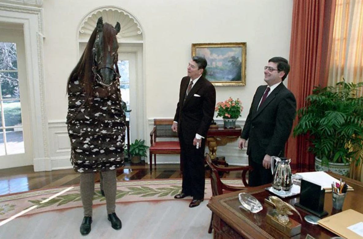 A whimsical moment: President Ronald Reagan receives an unusual visit from two individuals dressed as a horse in 1989.