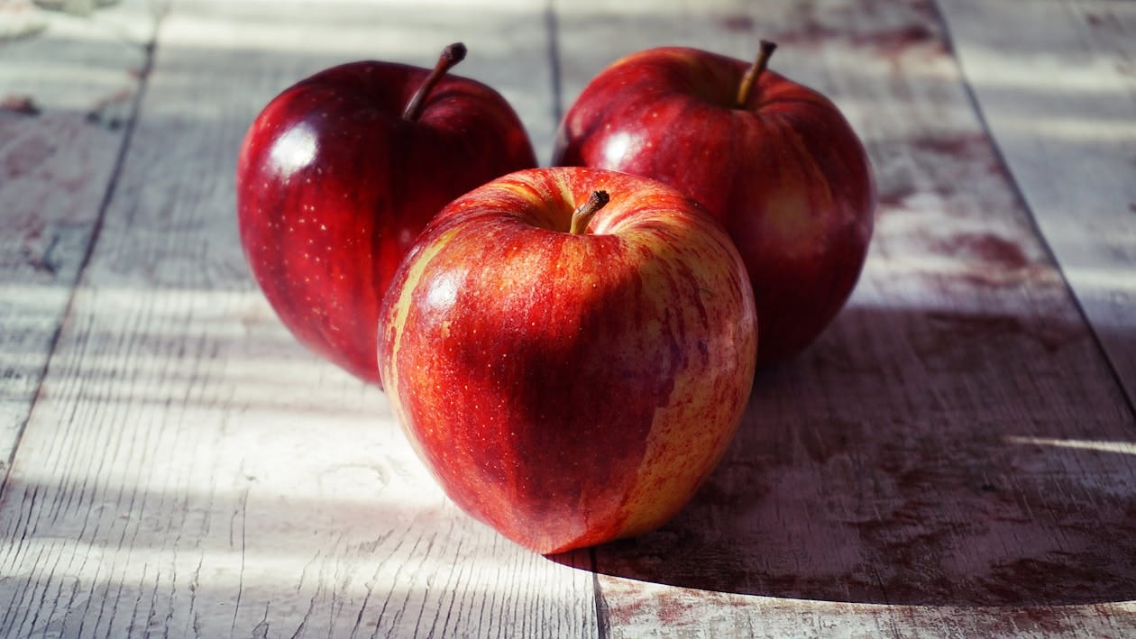 Free Three Red Apples on Wooden Surface Stock Photo Free Three Red Apples on Wooden Surface Stock Photo