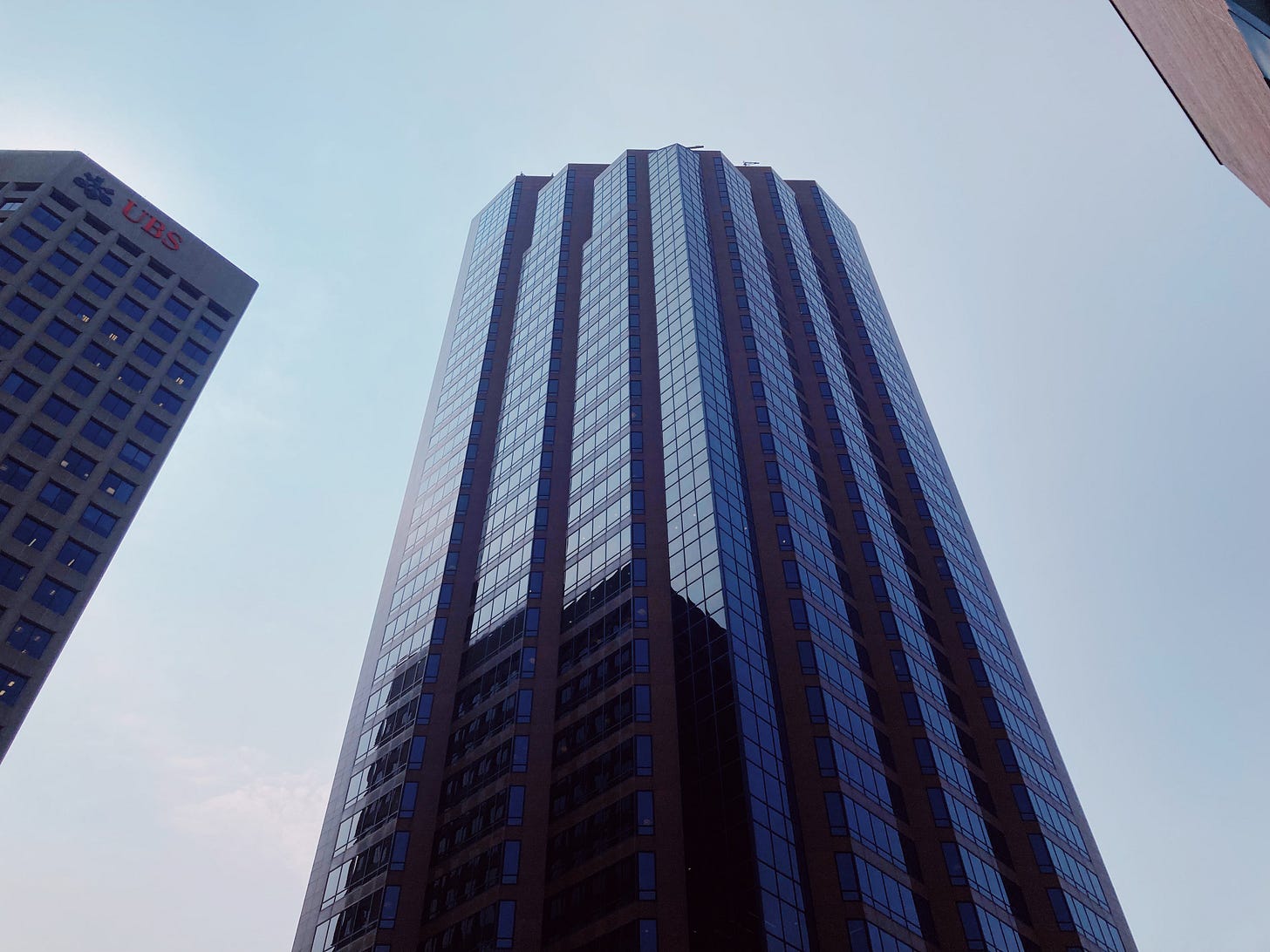 high rise wells fargo place building in st paul, glass reflects the clear blue sky