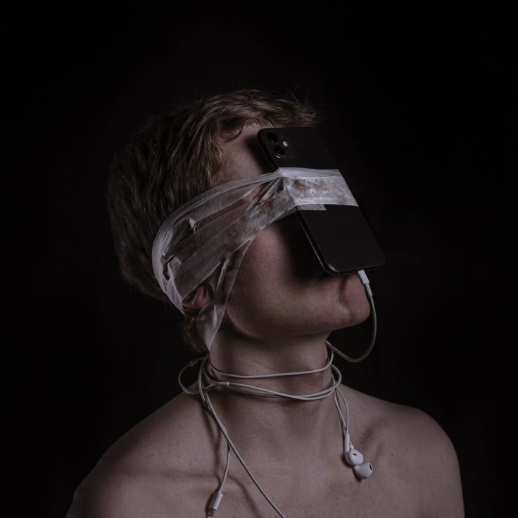 This may contain: a man with no shirt wearing a plastic covering over his face and blindfolded head