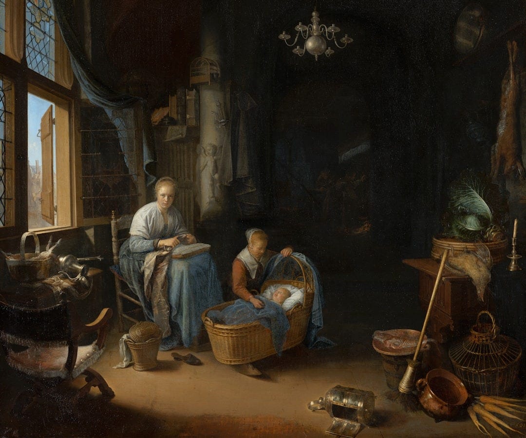 A woman and child in a dimly lit domestic interior.