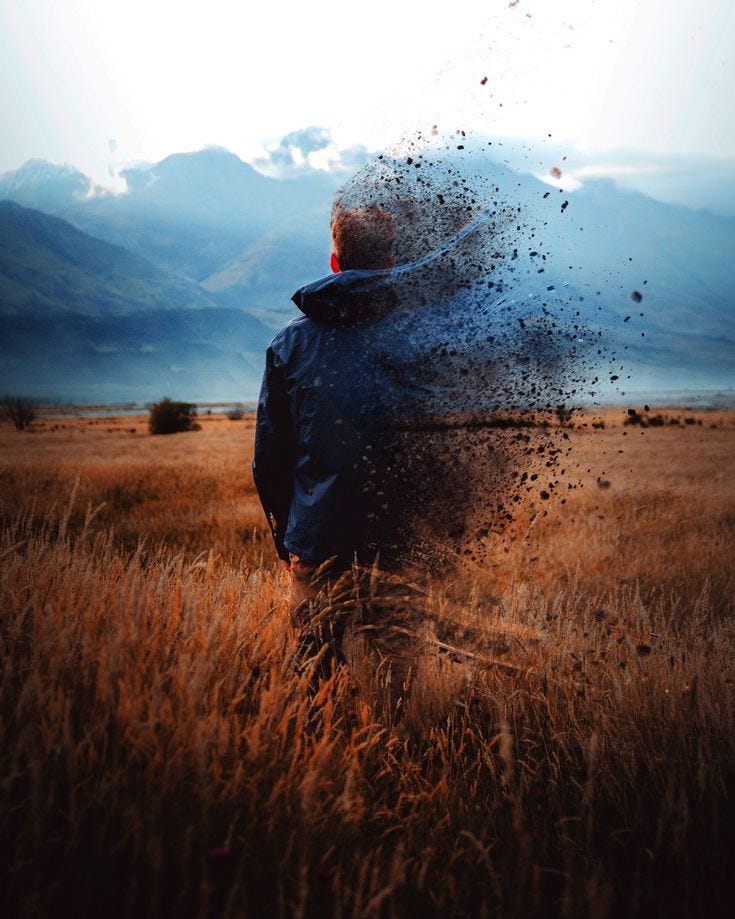 This may contain: a man standing in a field with his back to the camera, throwing dirt into the air