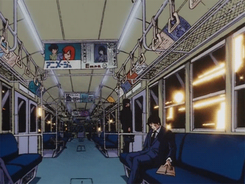 This may contain: a man in a suit and tie sitting on a subway car with blue seats, looking out the window