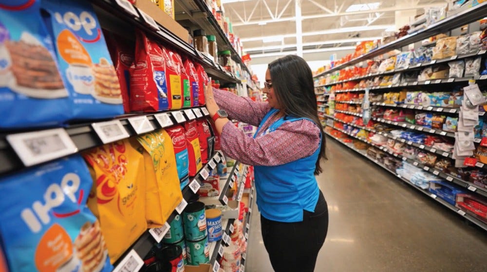 Associate in aisle with digital shelf labels
