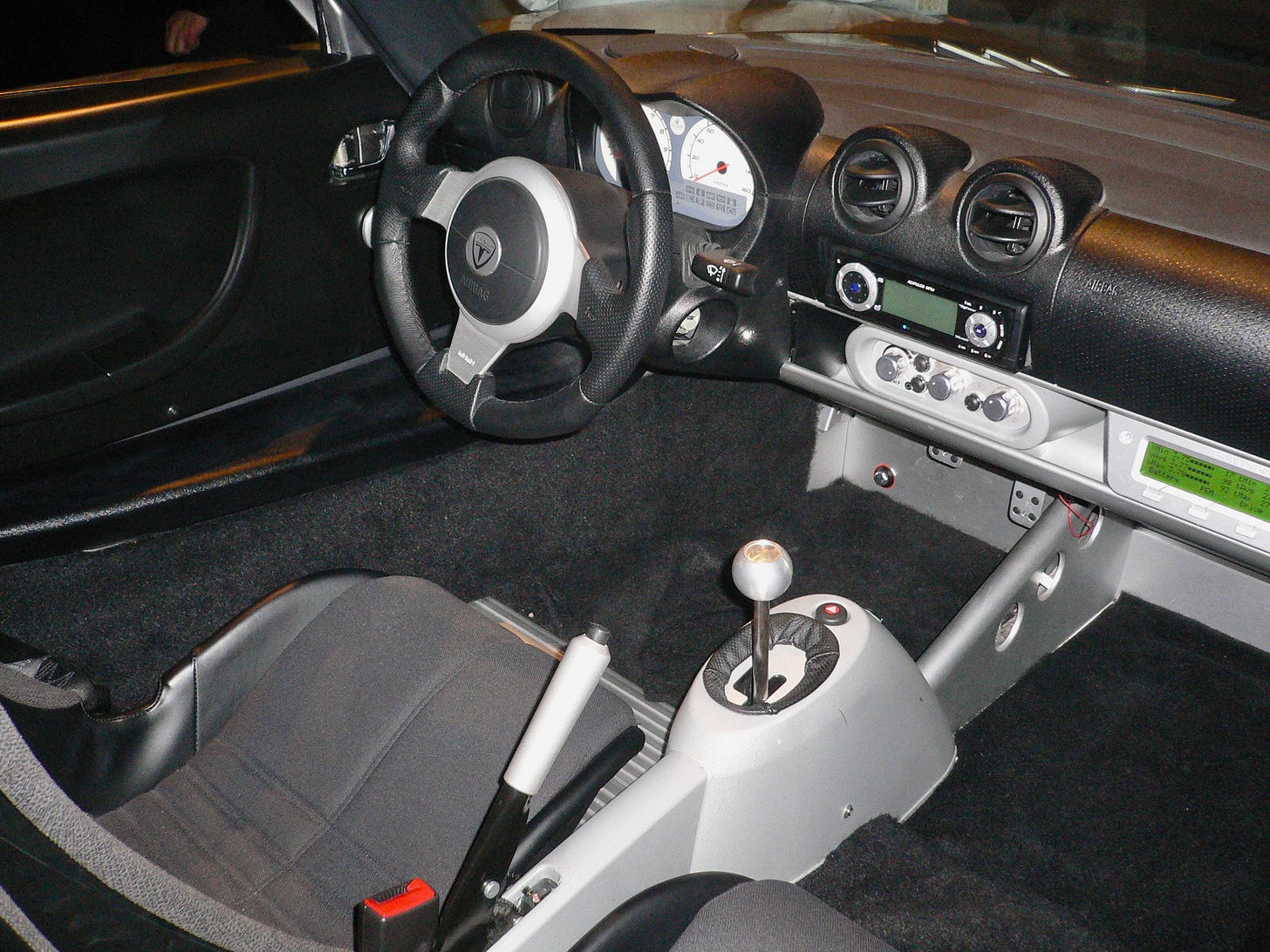 Empty driver's seat and steering wheel of a first-generation Tesla Roadster prototype from 2006 Empty driver's seat and steering wheel of a first-generation Tesla Roadster prototype from 2006