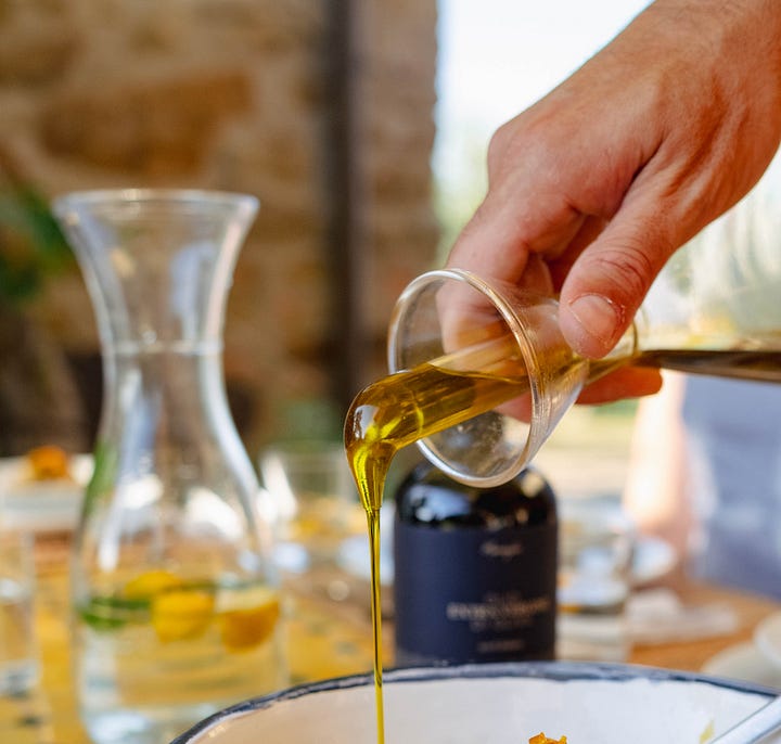 Four photos depicting candles at night, olive oil pouring from a spout, someone reading a book by the pool, and a field of flowers