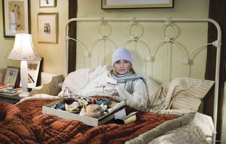 This may contain: a woman is laying in bed with her belongings This may contain: a woman is laying in bed with her belongings