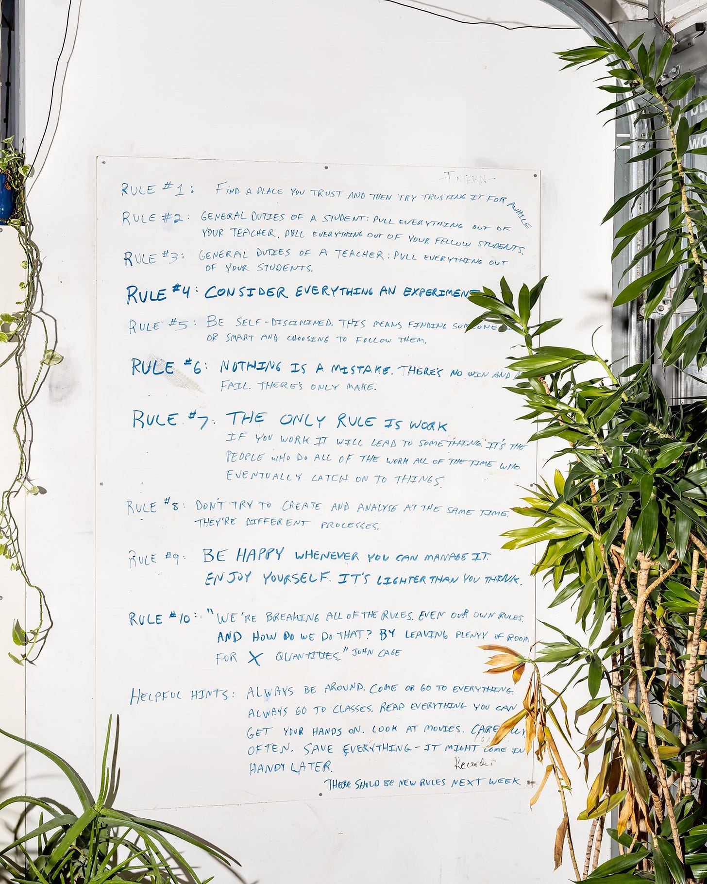 A white board with blue writing on it

Description automatically generated