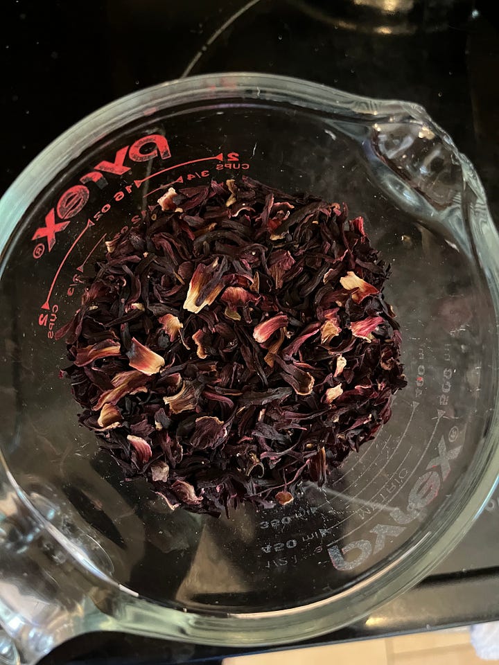Hibiscus Tea concentrate, with cinnamon, orange peel, and ice.
