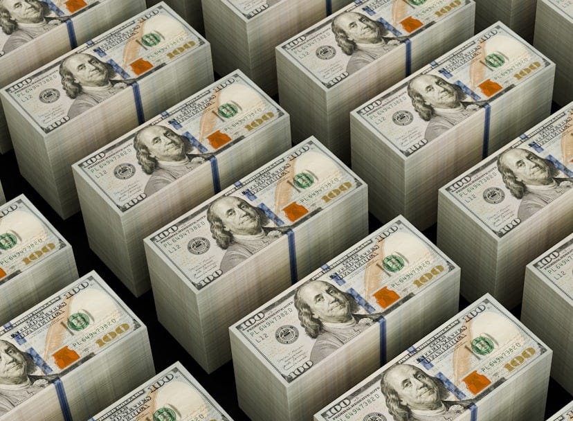 Stacks of hundred dollar bills are shown.