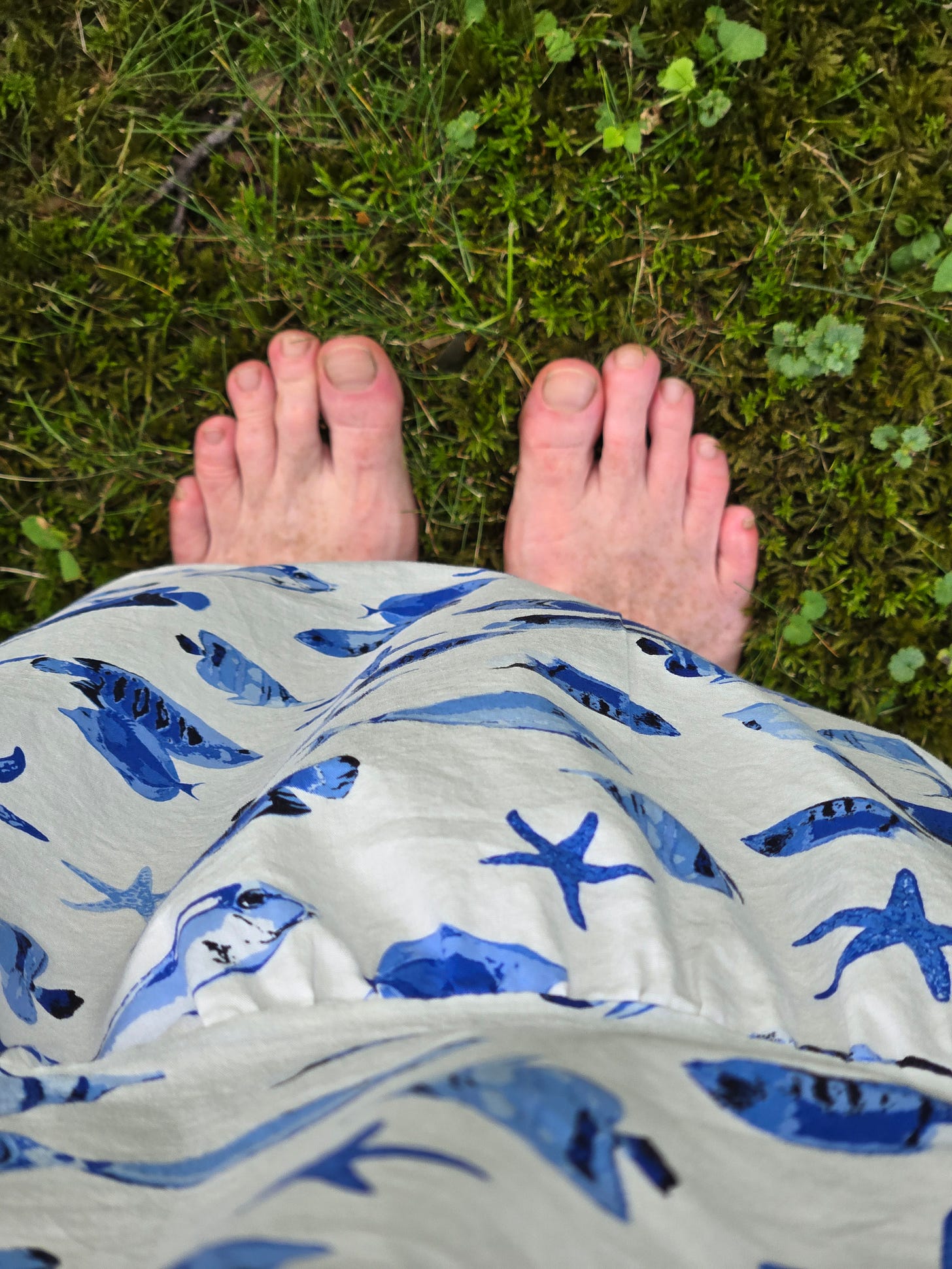 my two feet standing on soft mossy ground