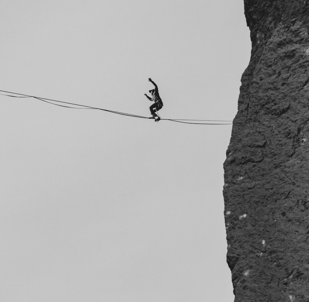 black bird on black wire during daytime