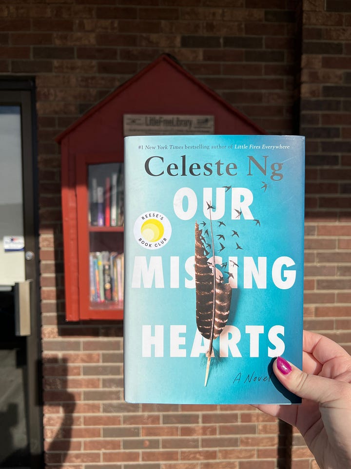 Four images of different Little Free Libraries. The top left image shows a hand holding up a copy of Our Missing Hearts by Celeste Ng in front of one of the libraries.