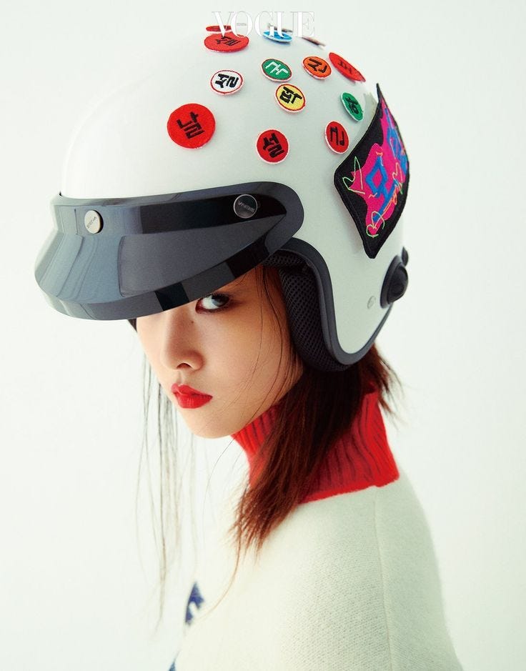 This may contain: a woman wearing a white helmet with buttons on it
